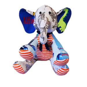 A custom memory elephant with the name 'Alfie' on on ear and a dinosaur on the other