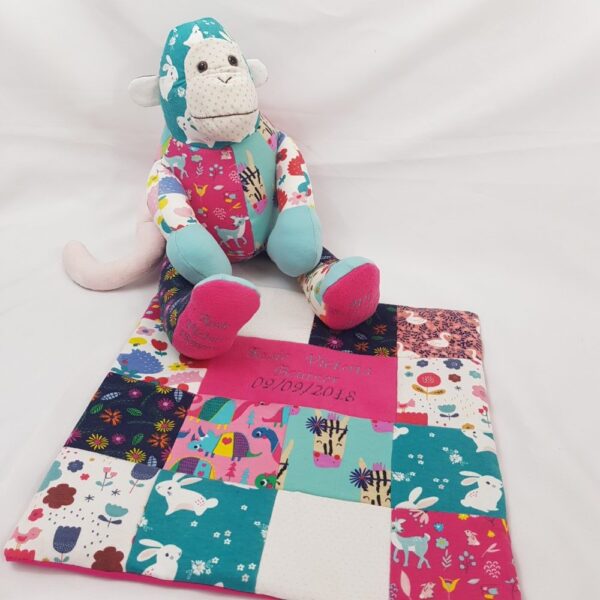 A keepsake memory monkey with a small patchwork blanket