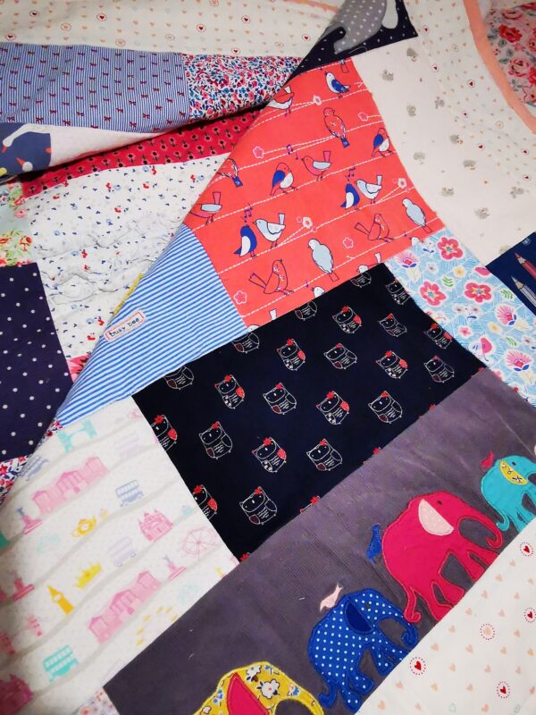 A patchwork memory quilt with a fold