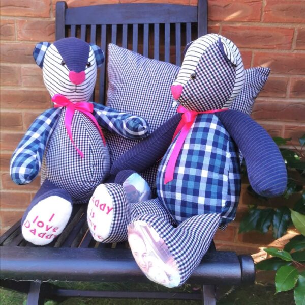 Two memory bears sat against a cushion on a chair