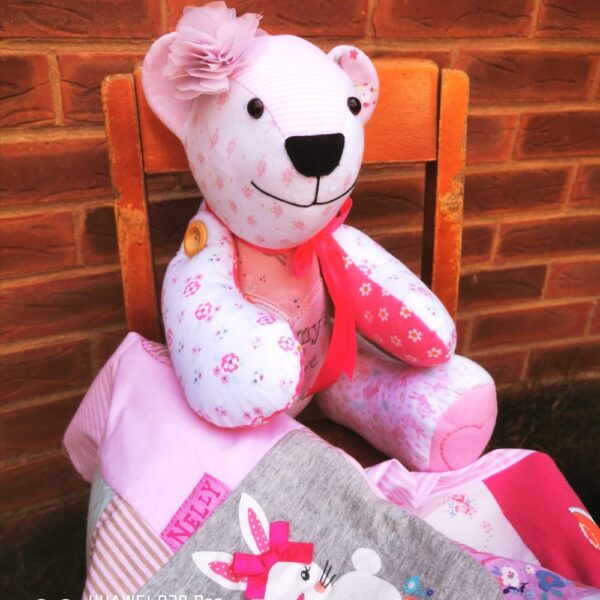 A pink memory bear sat on a wooden chair