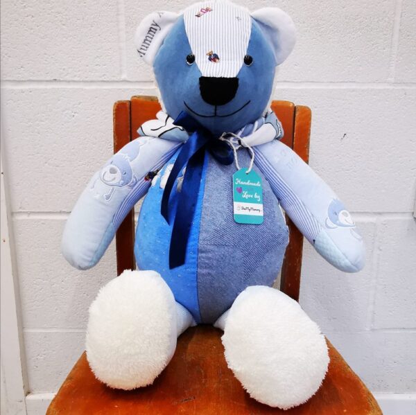 A blue memory bear sat on a wooden chair