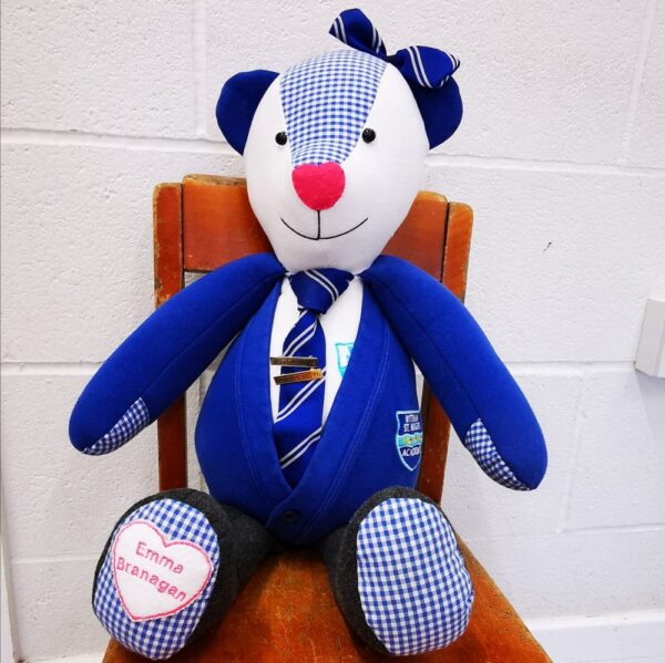 A memory bear made from a bright blue school uniform