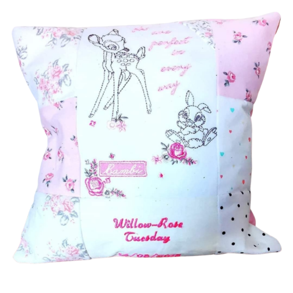 A pink and white memory cushion with Bambi and Thumper visible