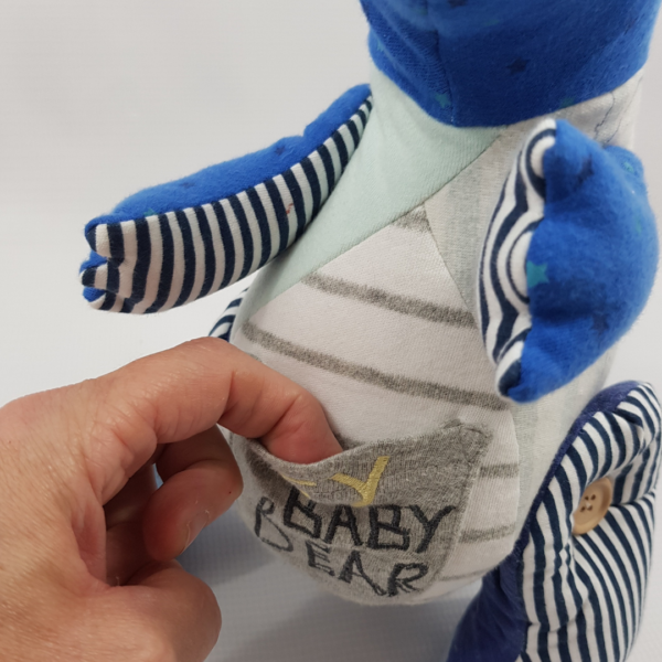 A tummy pouch on a dinosaur memory keepsake