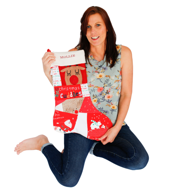 Bianca kneeling with a Christmas stocking