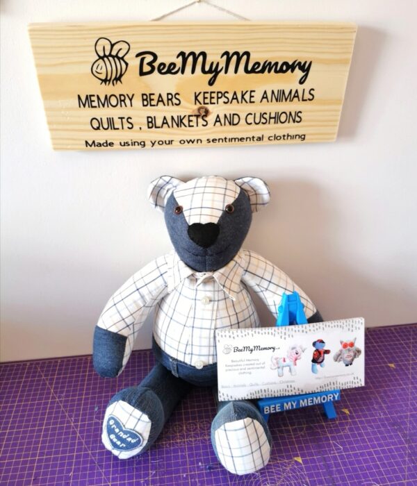 A memory bear sat with a gift voucher and a BeeMyMemory sign above it