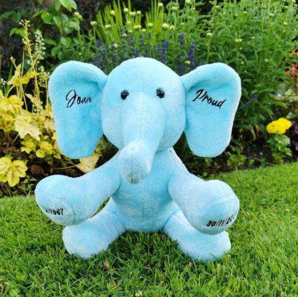 A baby blue memory elephant with custom embroidery on the ears and feet