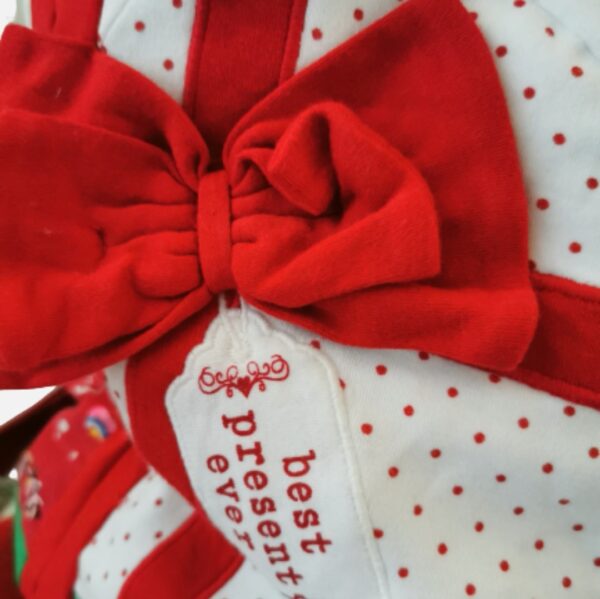 Up close view of a Christmas bow on a present sack