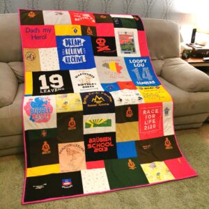 A patchwork memory single size quilt on a sofa