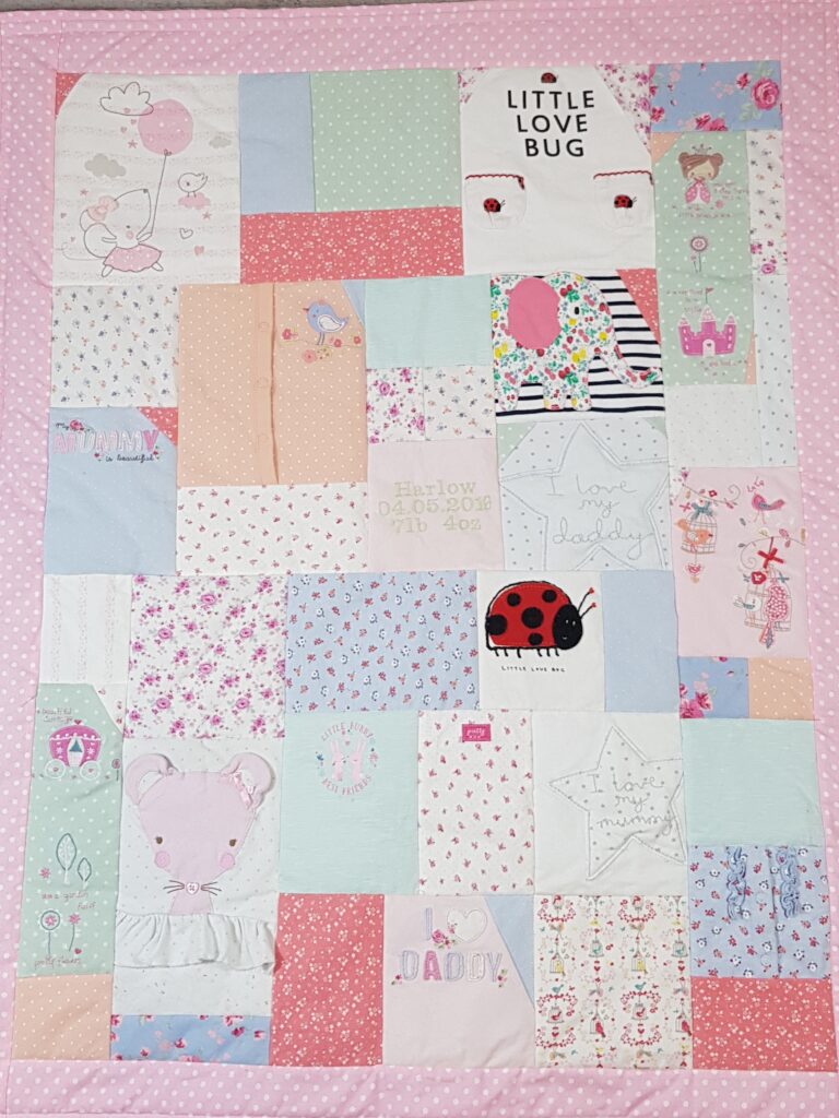 A completed memory blanket with pink colours