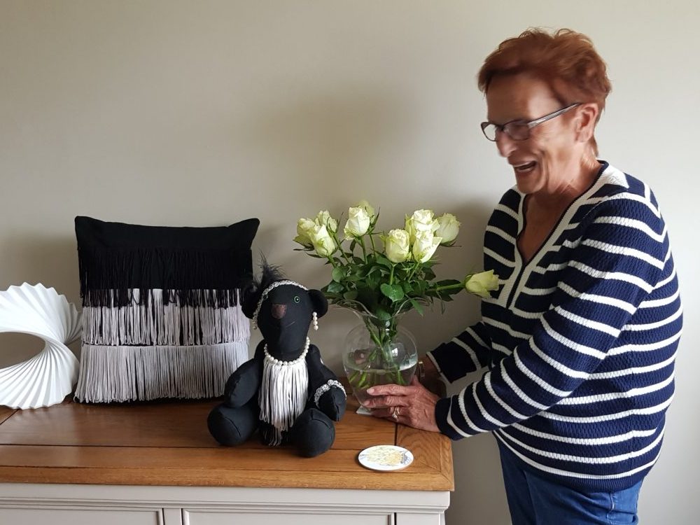 A lady stood with flowers and custom memory products