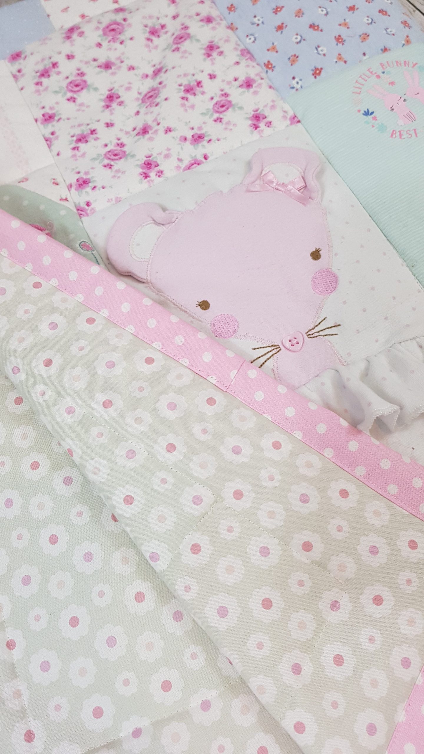 An up close look at a memory blanket with a pink mouse