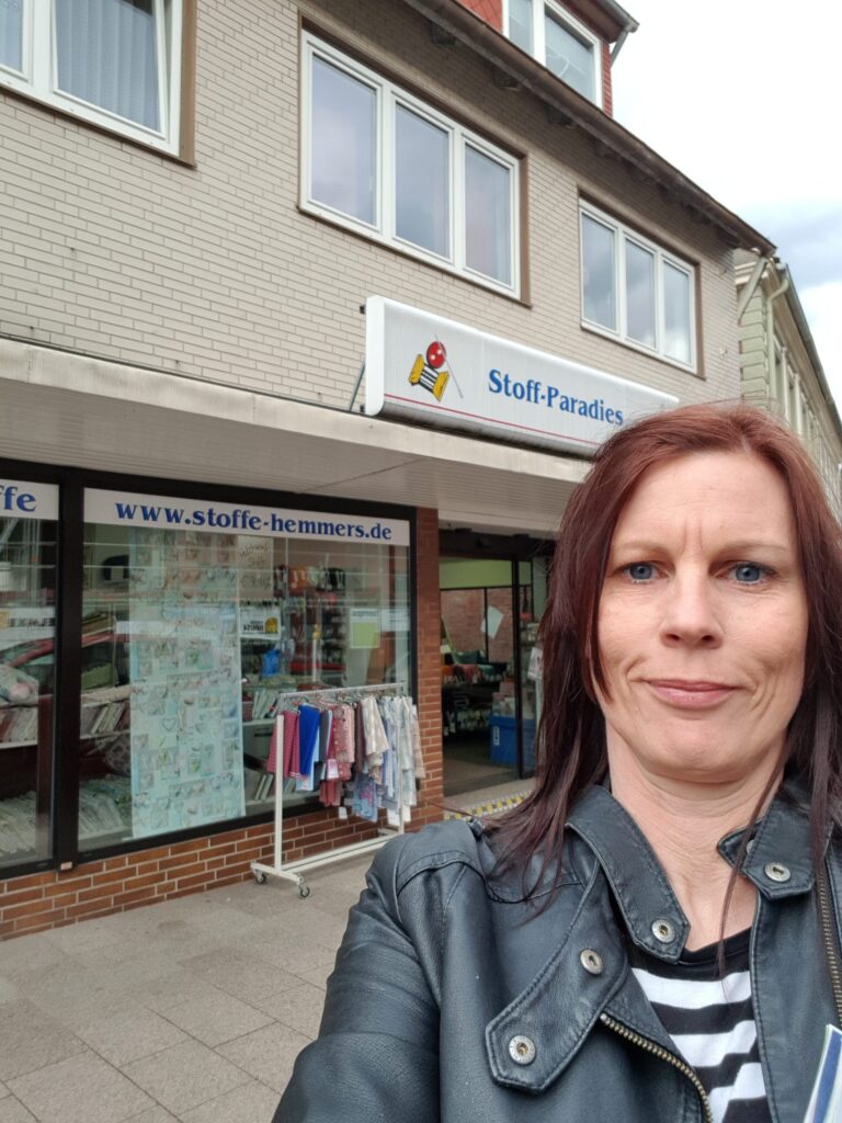 Bianca outside of a fabric shop called Stoff-Paradies