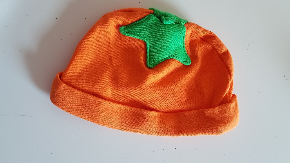 A child's pumpkin hat