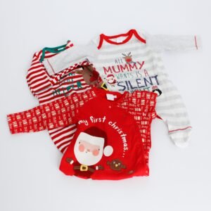 a selection of baby's christmas sleepsuits laid out