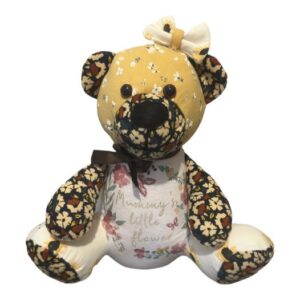 a memory bear made out of flowery baby clothes