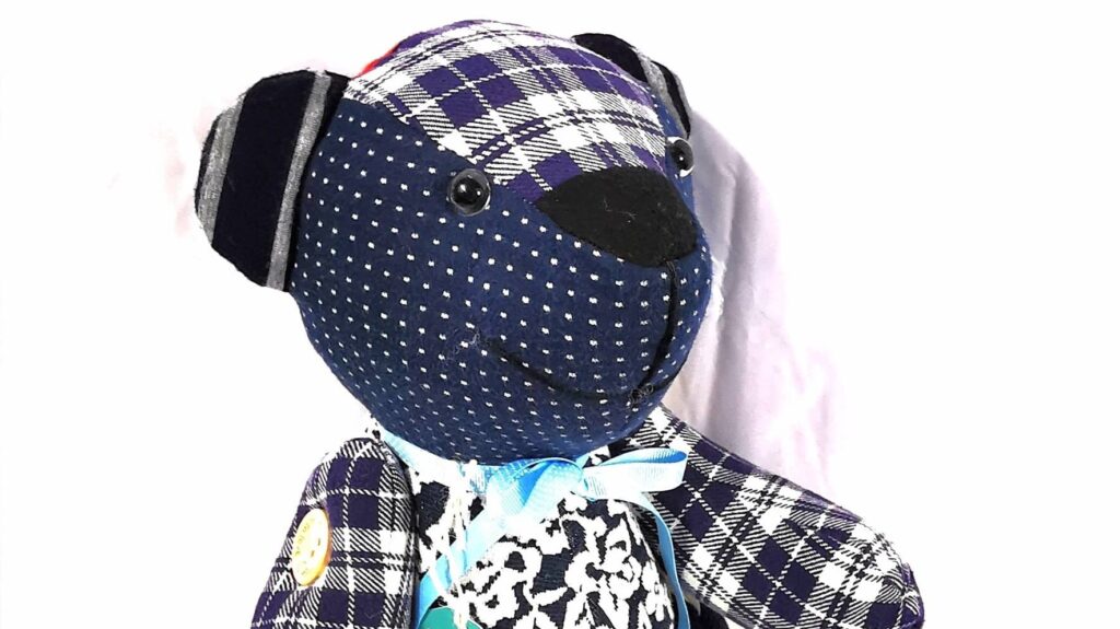 traditional button jointed remembrance bear with movable arms and legs