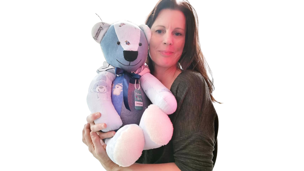 THE owner of Bee My Memory holding a large memory bear made out of baby clothes