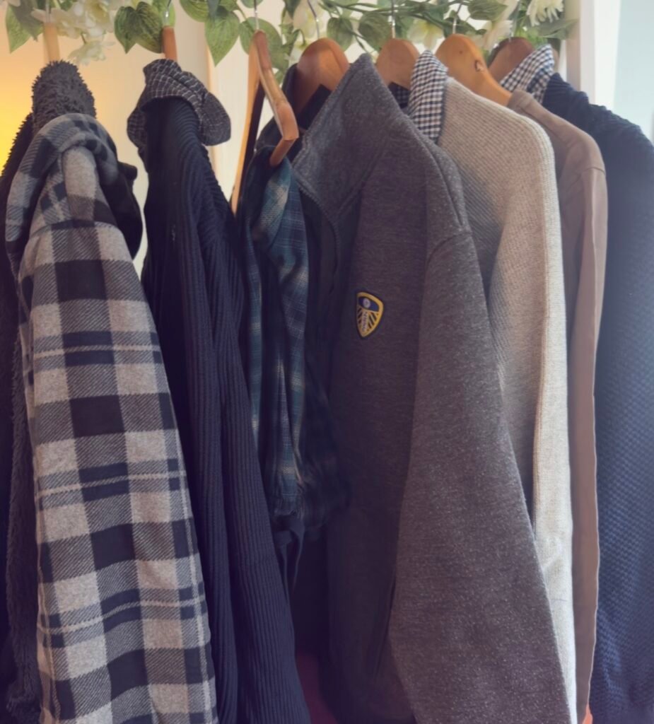 A rail of sentimental everyday clothing ready to be transformed into memory keepsakes.